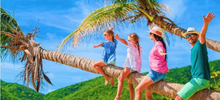 A happy family with kids enjoying a holiday on a beautiful Bali beach.